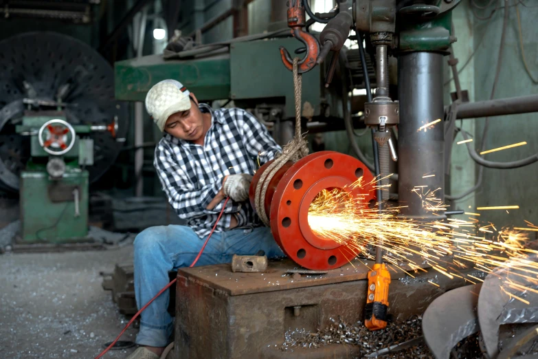 a man working with sparks in the factory