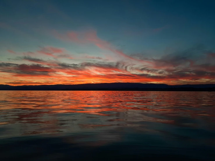 a view of the sunset from a boat in the water