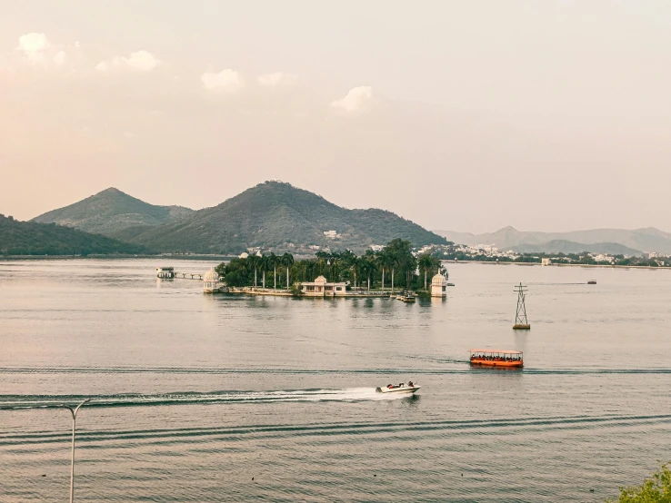 a boat in the water with a mountain background