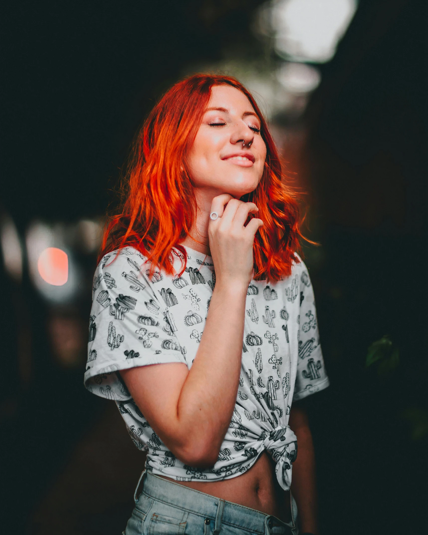 a young lady with red hair standing against the wall