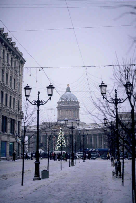 this is an outdoor area with snow on the ground and various street lamps