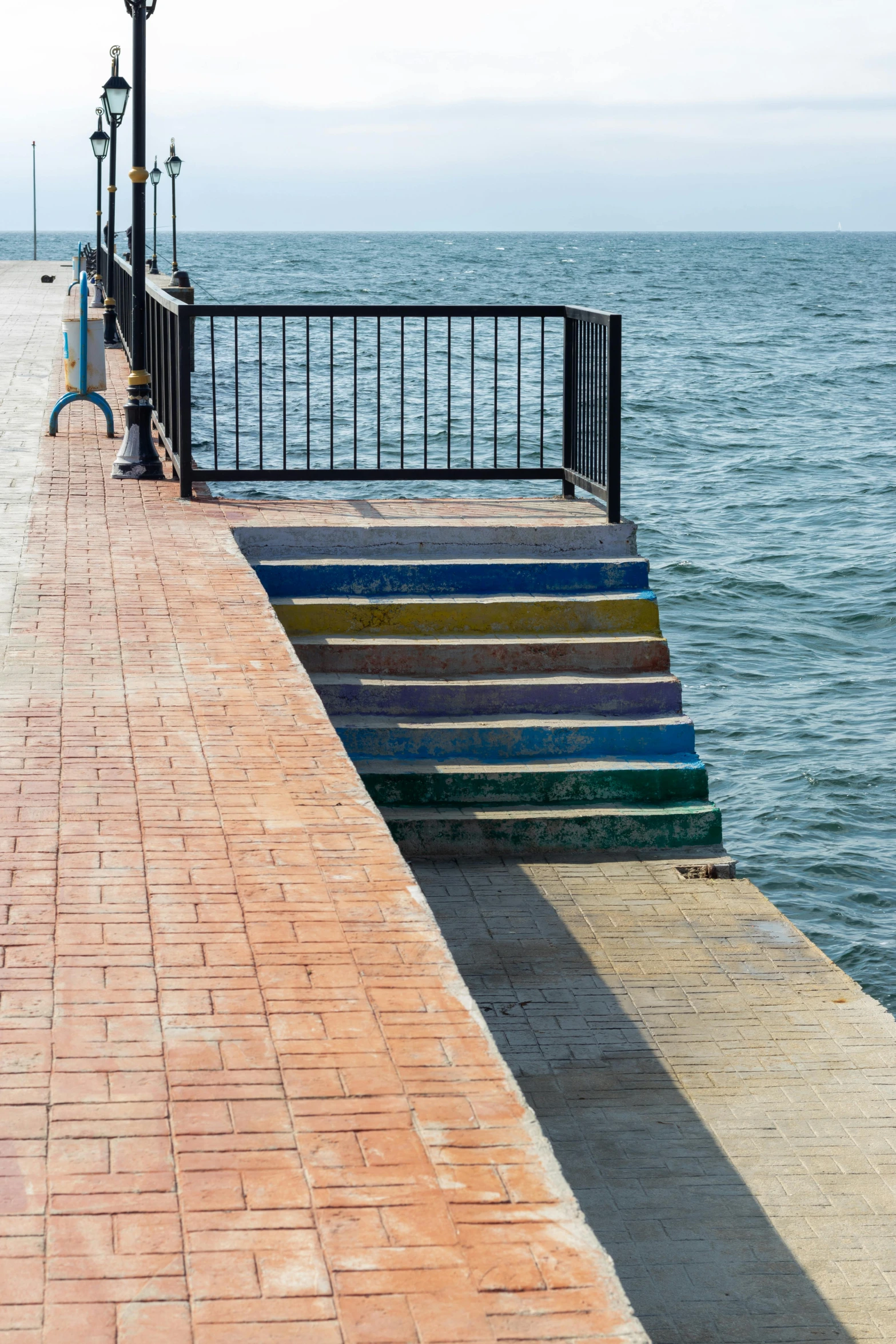 a man on a bench looking at the water