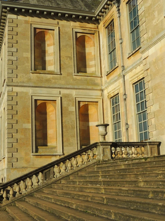 the steps lead up to an old building with double doors