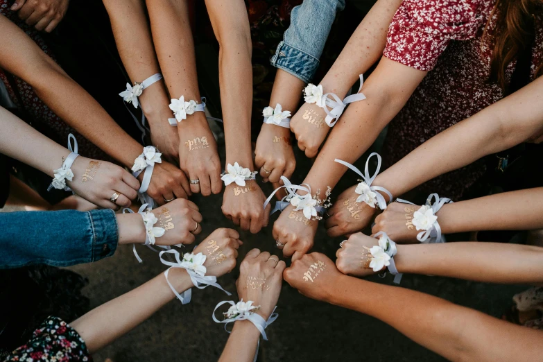 a bunch of people with their hands together