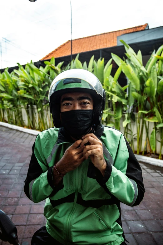 a man wearing a mask riding a motorcycle