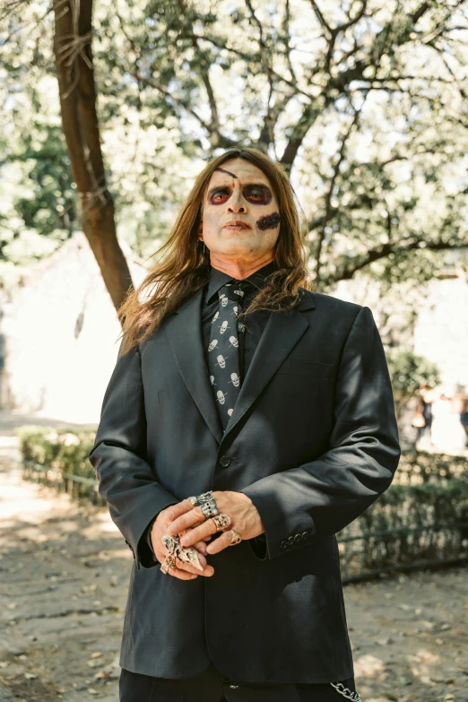 a man in a suit and tie standing outside