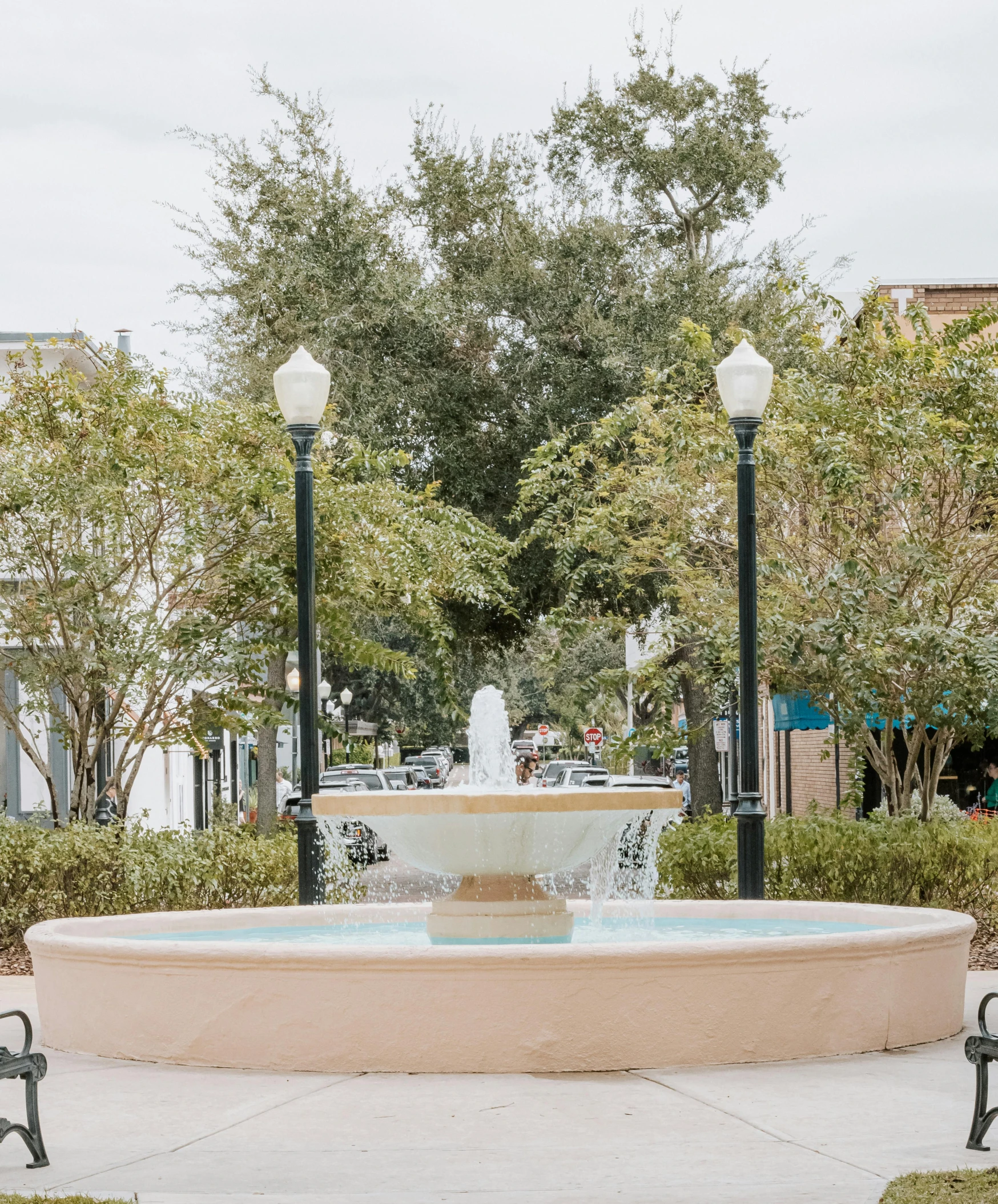 a fountain with lights in the middle of a street