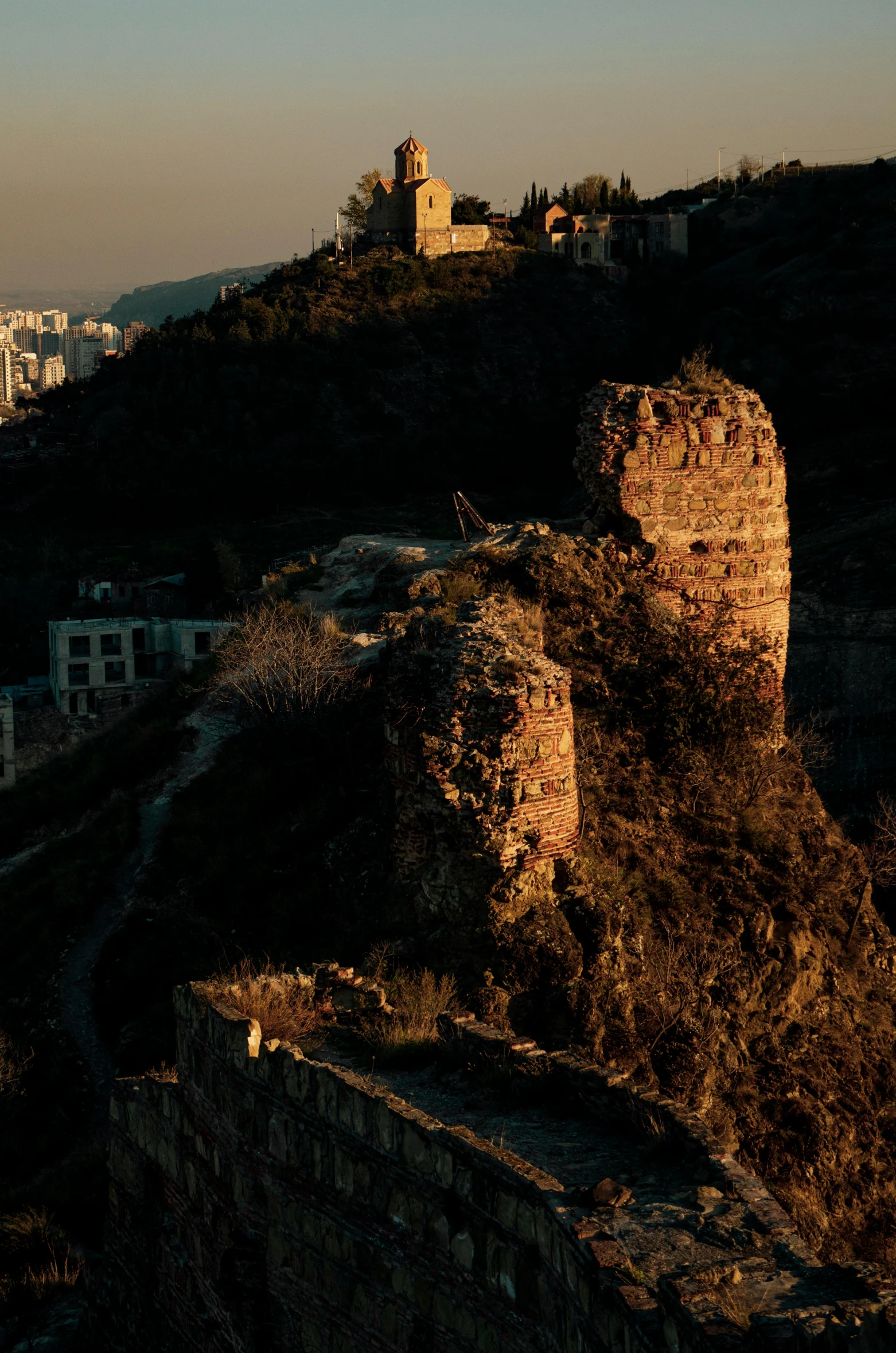 the view from an overlook point shows buildings and a hill