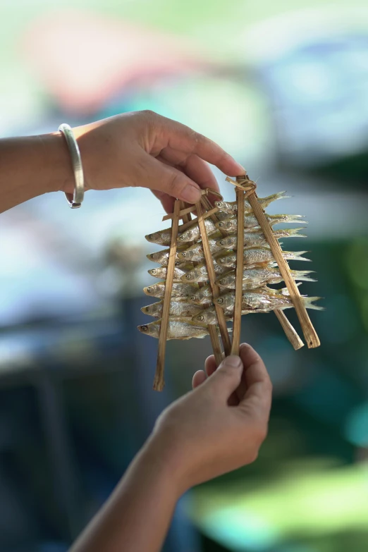 a hand is holding a bunch of small pins