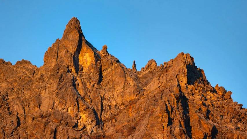 large rocky mountain tops against a blue sky