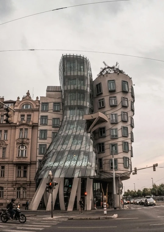 a car driving down a road next to a large building