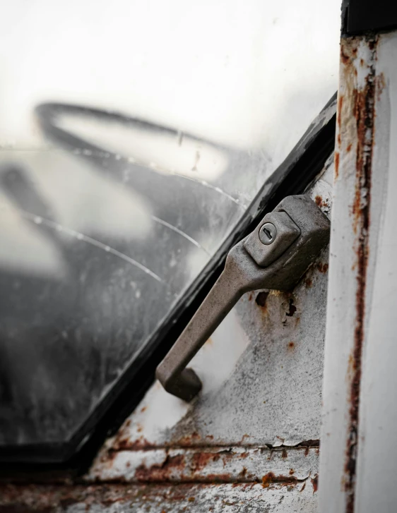 a latch on an old, weathered, door handle