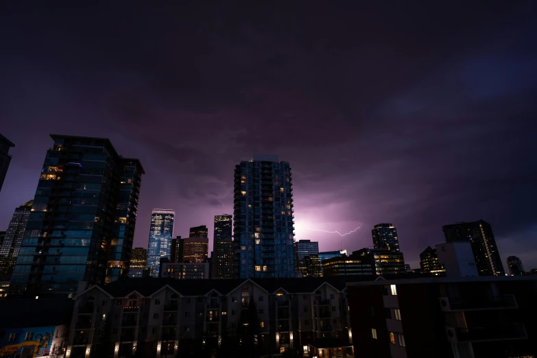 a purple light is shining over the city skyline