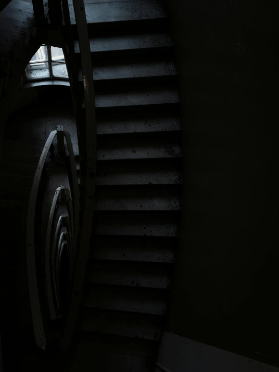 stairs lead up into the dark room with light on them