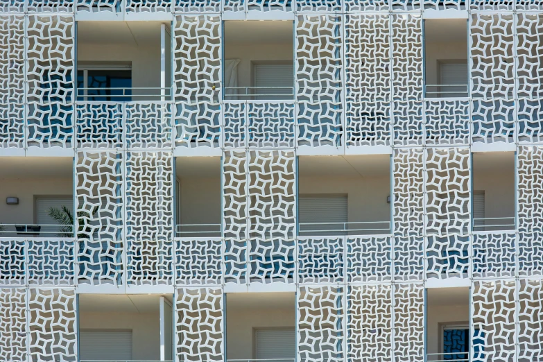 an apartment building with large balconies and blue windows