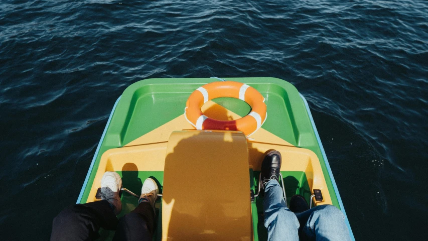 two people on a small boat in the water