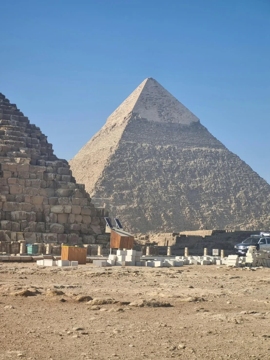 a large pyramid sits in the middle of a desert