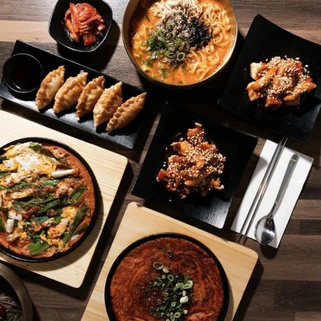 a number of different dishes on wooden boards