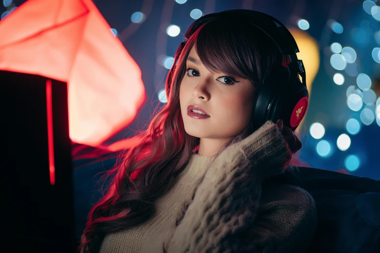 a woman with headphones standing next to a lamp