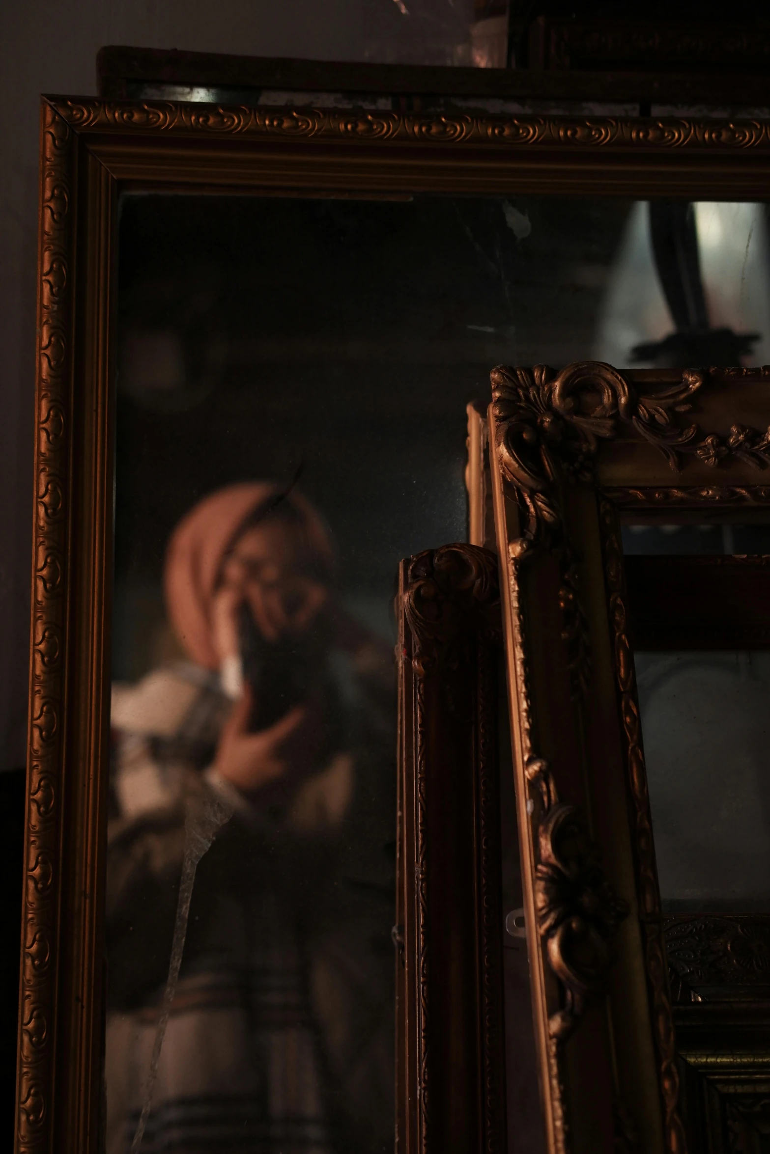 a po of a young man holding a cigarette in front of a mirror