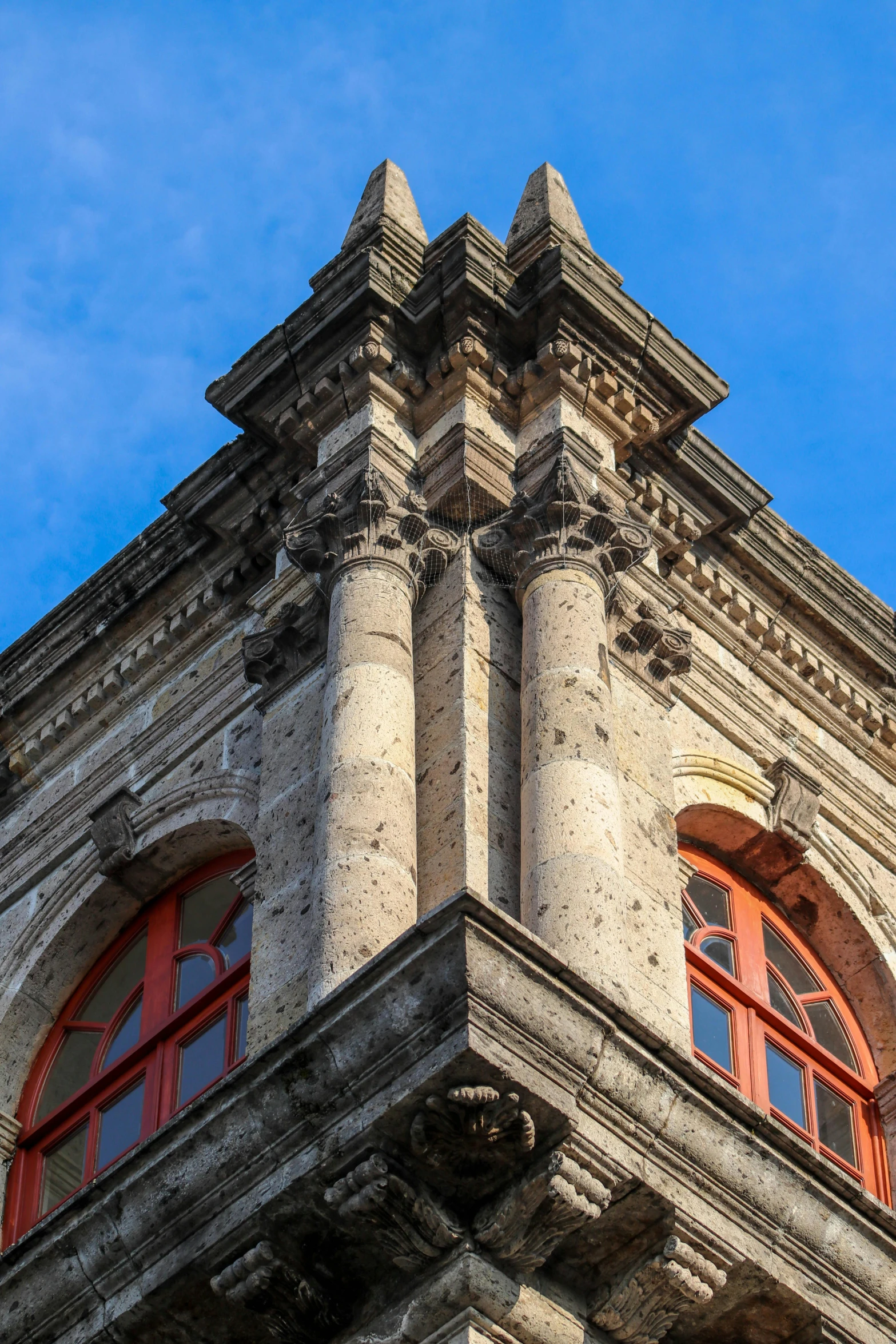 an old building made of stone and red shutters