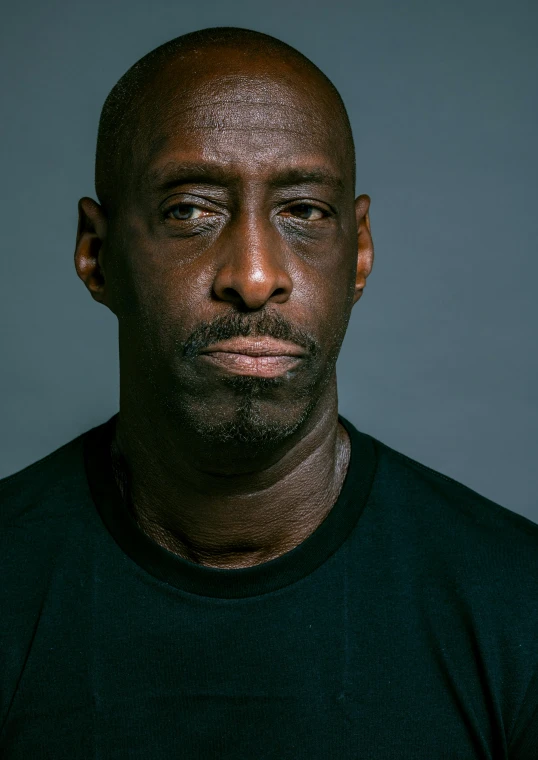 a close up po of a man with a black shirt