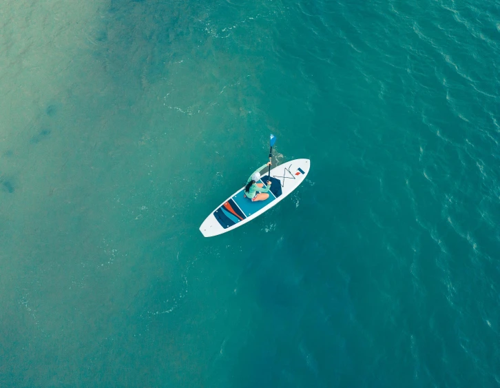 a person that is in a white boat in the water