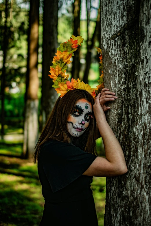 a woman with makeup holding a tree