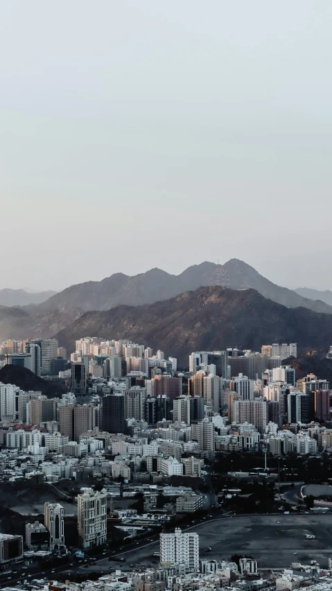 a city is shown from above with mountains in the background