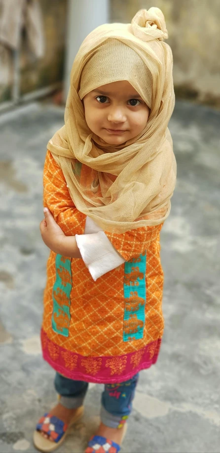 a little girl dressed in a muslim garb