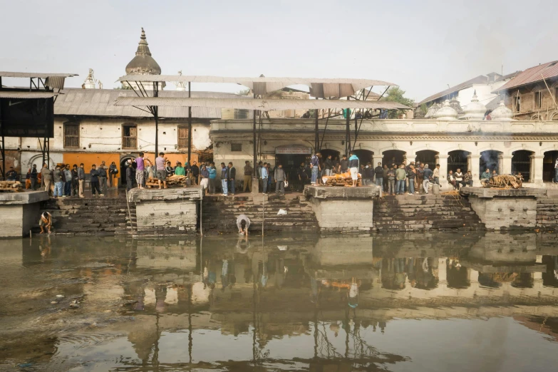 people gather at an old water town for drinks