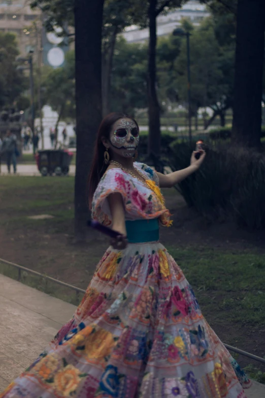 the girl in the colorful gown is posing for the camera