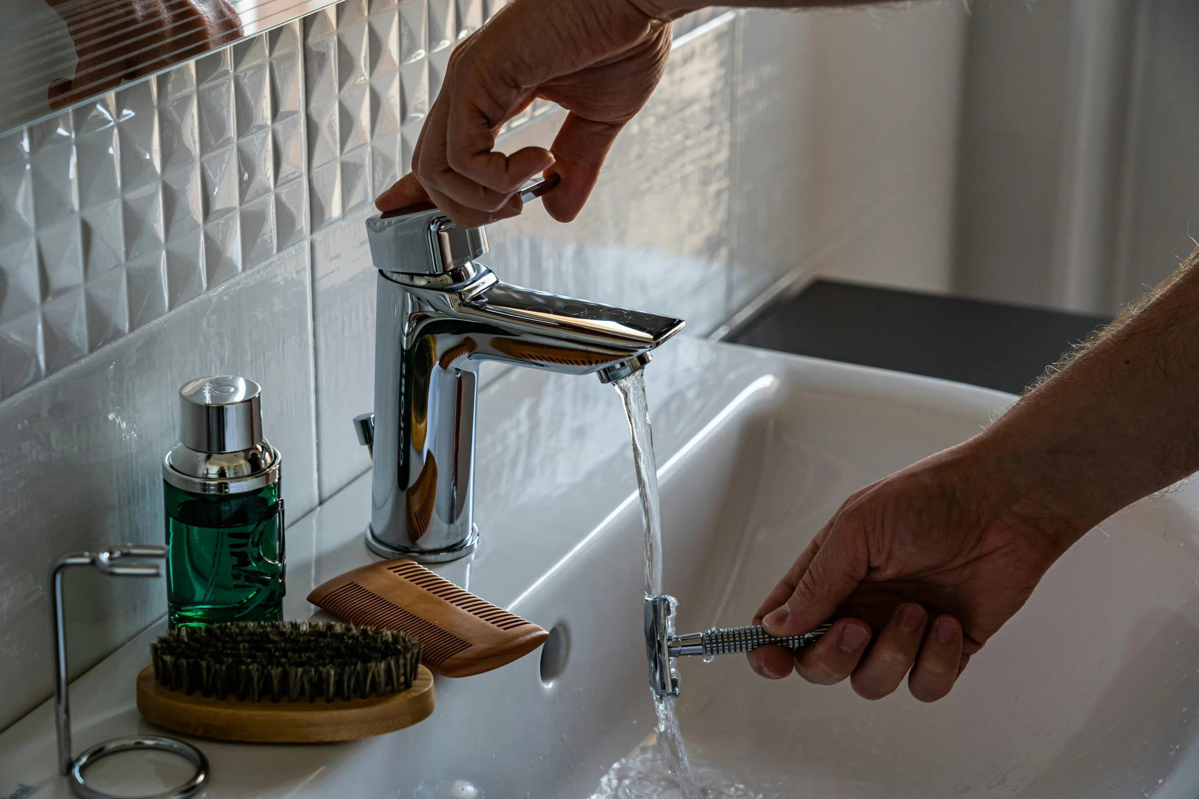 a person washing their hands with the help of a hairbrush