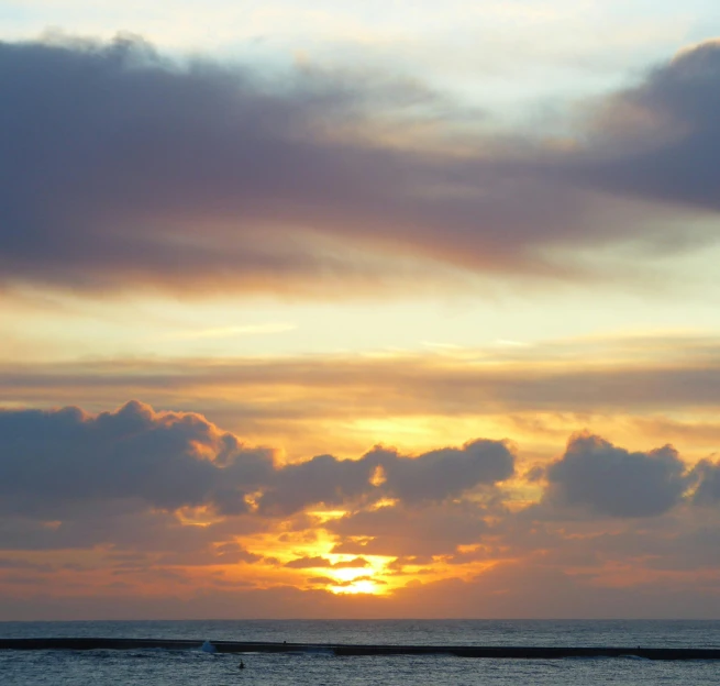 a view of the setting sun over a beach