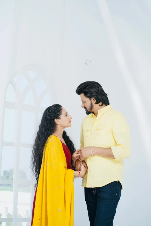 an attractive young couple standing close together