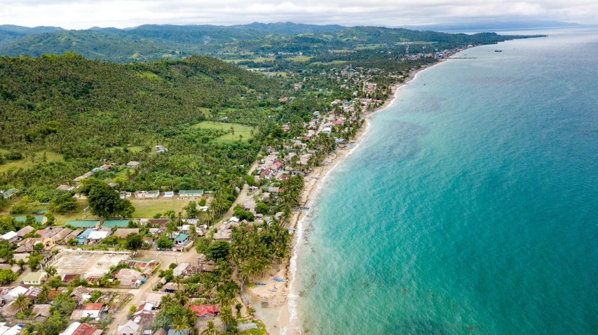 the aerial view of the island with the water's edge is shown