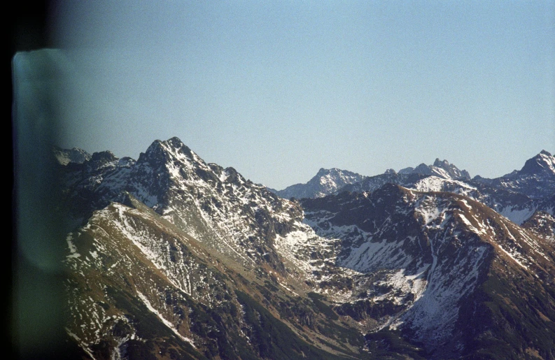 a large mountain range with trees growing on top