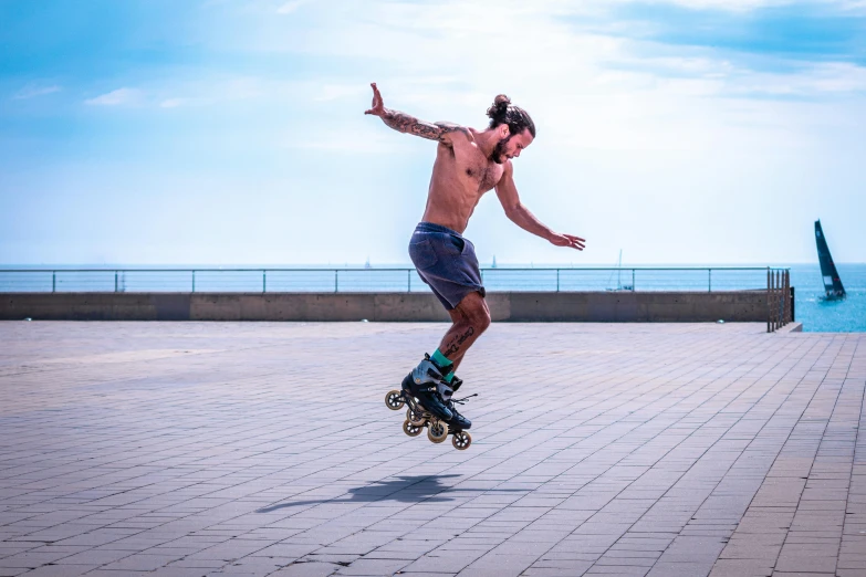 a man does tricks on a skateboard near the water