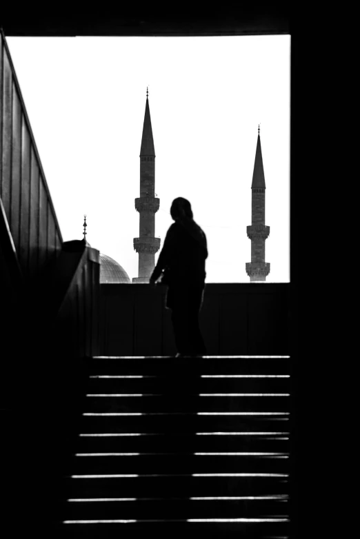 a person walking up a set of stairs next to a building