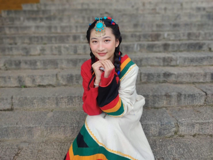 a beautiful woman standing on steps posing for a picture