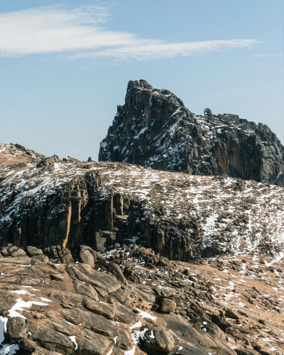 a large rock mountain covered in lots of snow