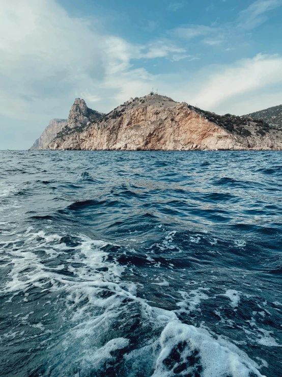 a very large body of water next to a rocky island