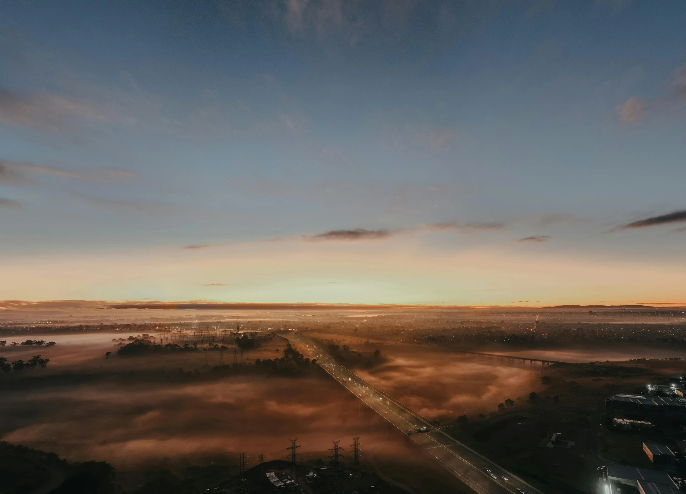 a foggy city street in the middle of a dusk