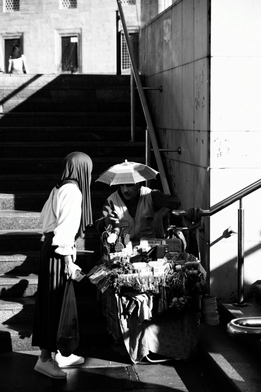 an asian woman with a white umbrella is near the stairs