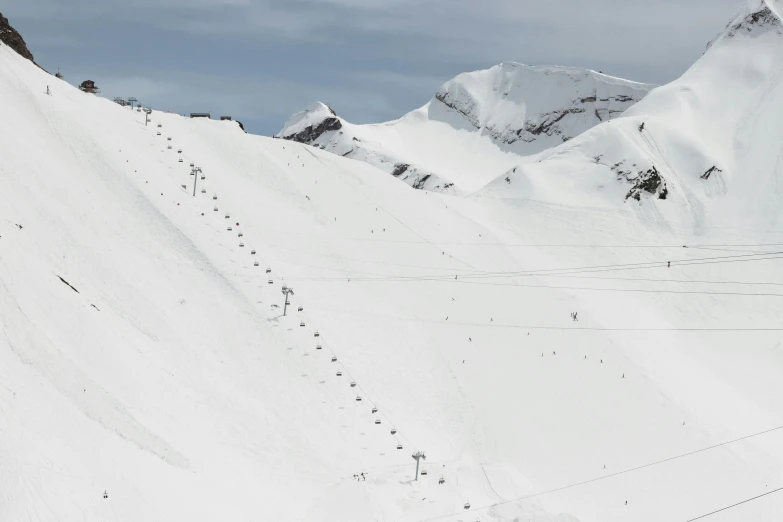 two people are skiing down a slope with very high snow