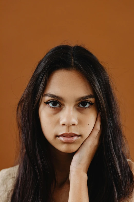 a woman in a white shirt with long hair