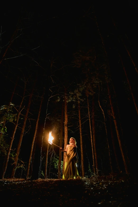 a couple standing under a street light in the woods