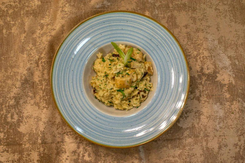 a white bowl filled with food on top of a wooden table