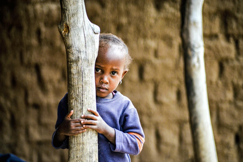 a  holding onto the back of a wooden stick