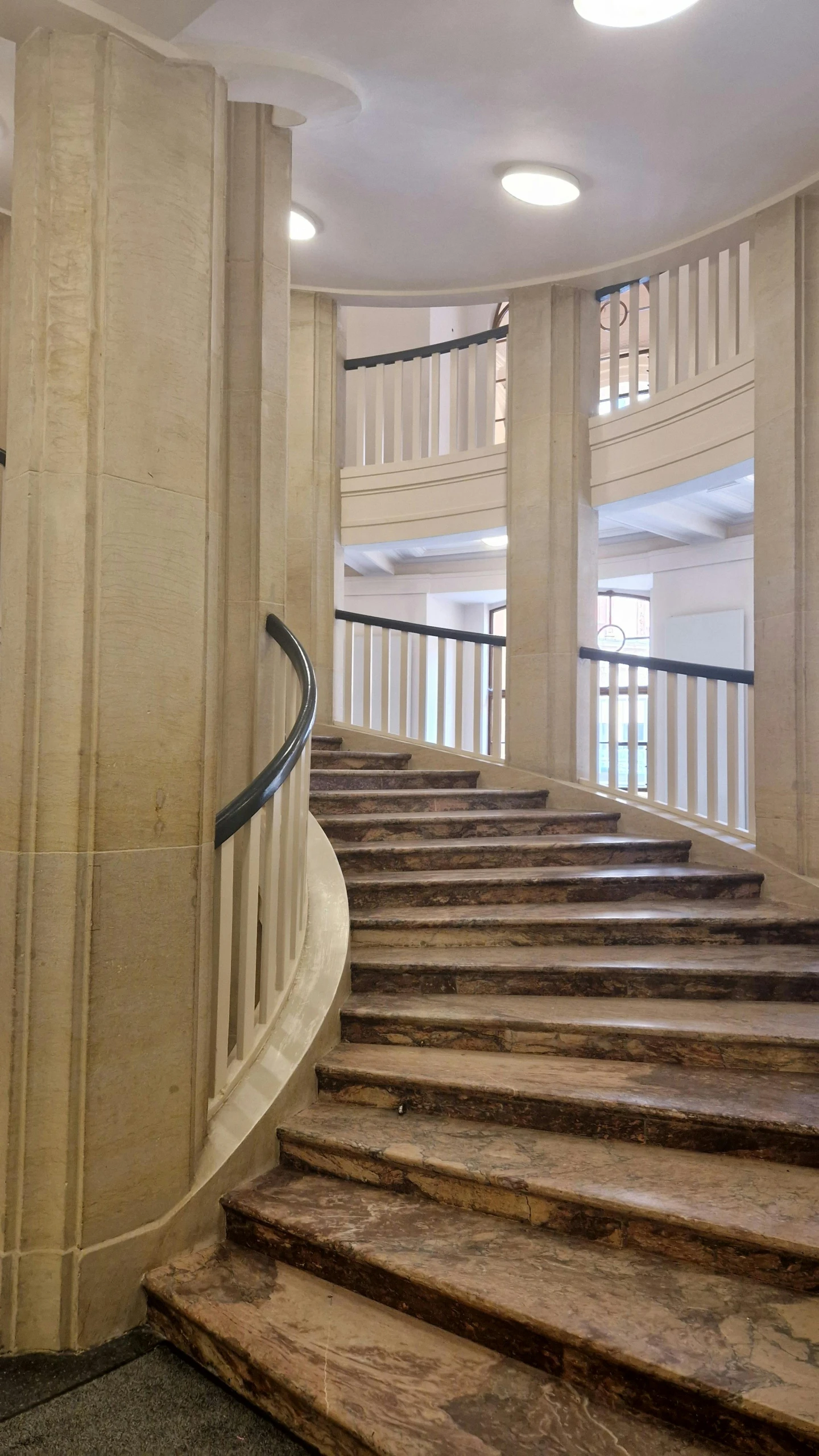 a set of stairs in an empty room with a window in the background